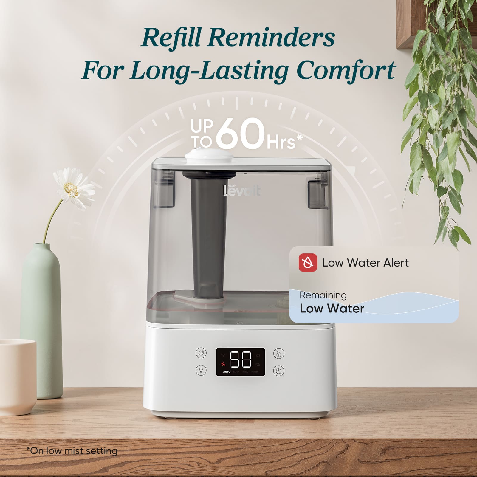 Humidifier with refill reminders and low water alert on a wooden surface with a plant in the background.